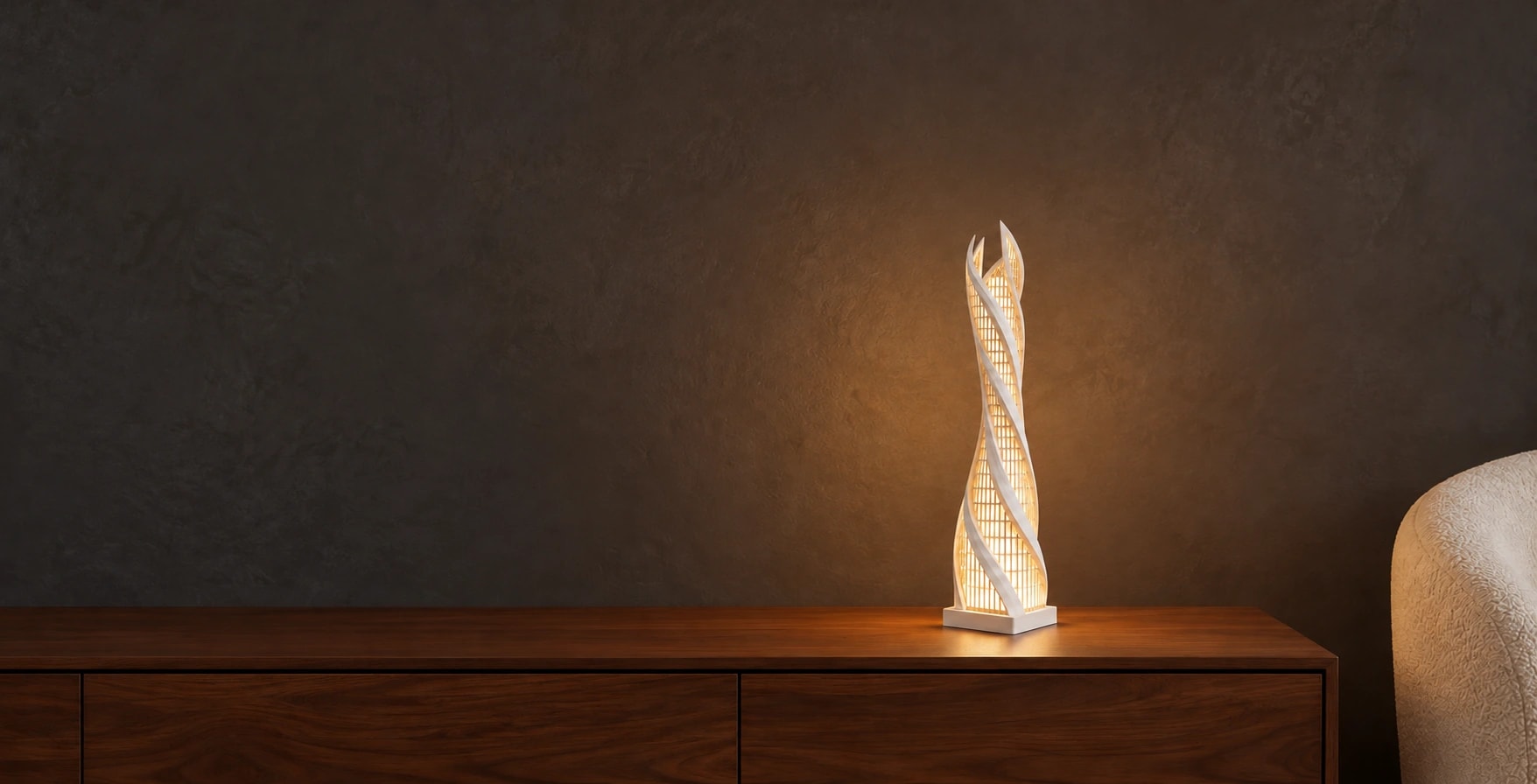 The Helix Lantern Lamp, its fine white ribbons illuminated on a walnut console