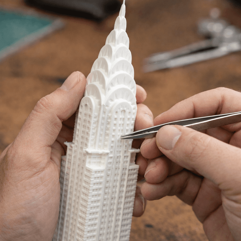 Hands finishing a printed lamp with tweezers